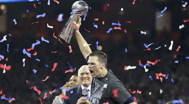 New England Patriots' quarterback Tom Brady holds the Vince Lombardi trophy after his team defeated the Atlanta Falcons to win Super Bowl LI in Houston, Texas, Feb. 5, 2017.