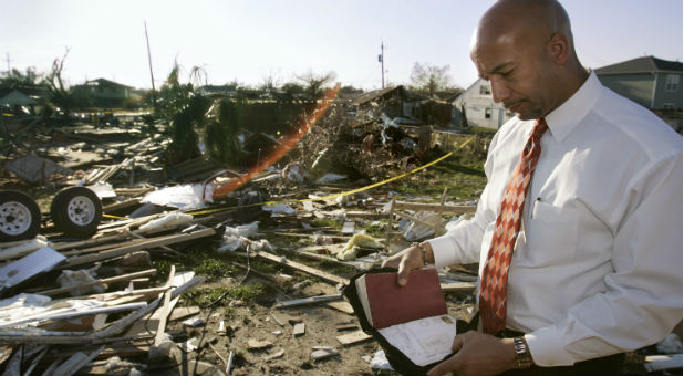 Mayor Ray Nagin looks over the Bible of an 85-year-old woman who was killed during a tornado in a government-provided trailer at the site of her home in the Pontchatrain Park neighborhood of New Orleans