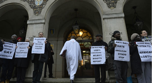 A member of the continuing praying presence enters the church house during a vigil against Anglican homophobia outside the General Synod of the Church of England in London