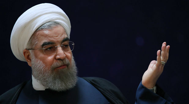 Iran's President Hassan Rouhani gestures as he speaks during a ceremony