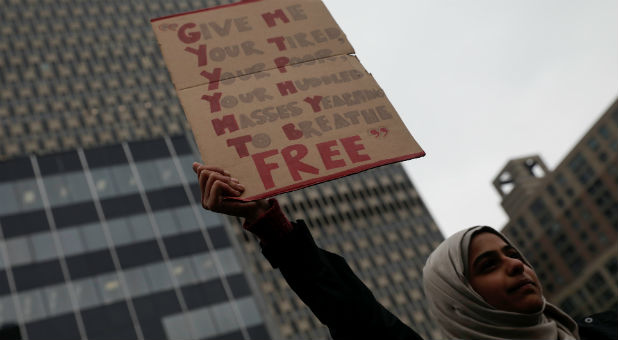 A Muslim New York City high school student holds a sign during a demonstration by students against U.S. President Donald Trump's immigration policies in lower Manhattan