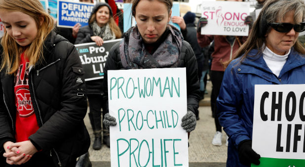 Pro-life activists gather outside the Supreme Court for the National March for Life rally in Washington, DC
