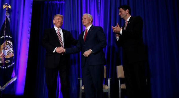 U.S. President Donald Trump is greeted by Vice President Mike Pence and House Speaker Paul Ryan (R) as he arrives to speak at a congressional Republican retreat in Philadelphia, Jan. 26, 2017.