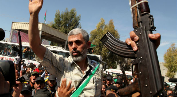 Hamas leader Yehya Al-Sinwar gestures as he arrives with Palestinian prisoners at the Rafah crossing with Egypt in the southern Gaza Strip Oct. 18, 2011.