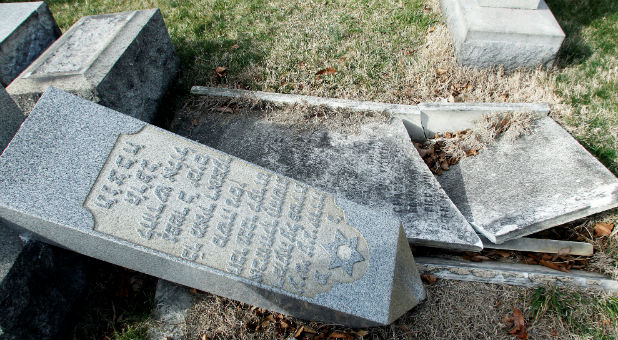 A headstone, pushed off its base by vandals, lays on the ground near a smashed tomb in the Mount Carmel Cemetery, a Jewish cemetery, in Philadelphia, Pennsylvania. About 100 headstones were knocked over, police said, in an incident that apparently took place after dark on Feb. 25.
