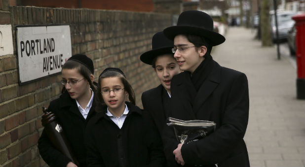 A group of young men walk to a synagogue during the celebrations of the Jewish festival of Purim in Stamford Hill in north London, Britain, March 24, 2016.