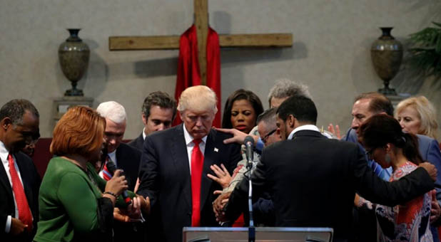 Praying over President Donald Trump