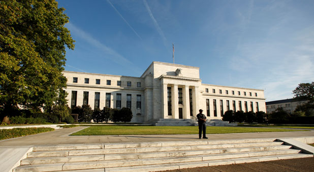 A police officer keeps watch in front of the U.S. Federal Reserve building in Washington, D.C.