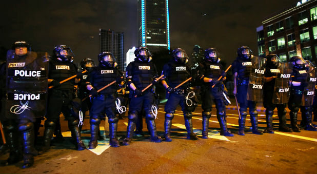 Riot police prepare to push protesters off the highway during another night of protests over the police shooting of Keith Scott in Charlotte, North Carolina