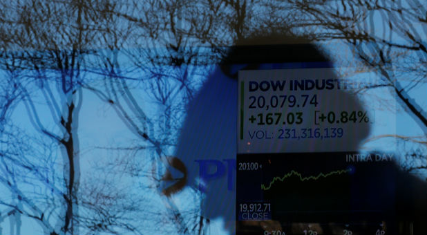 News of the Dow Jones Industrial average passing 20,000 plays on television