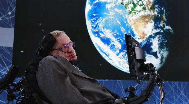 Physicist Stephen Hawking sits on stage during an announcement of the Breakthrough Starshot initiative