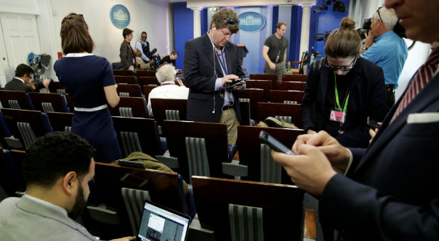 Journalists work in the briefing room at the White House in Washington.