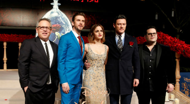 Director Bill Condon and actors Dan Stevens, Emma Watson, Luke Evans, and Josh Gad (L-R) pose for photographers on the red carpet for the film
