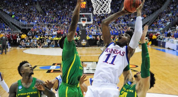 Kansas Jayhawks guard Josh Jackson (11) goes up for a shot as Oregon Ducks guard Dylan Ennis (31) and forward Dillon Brooks (24) defend during the second half in the finals of the Midwest Regional of the 2017 NCAA Tournament
