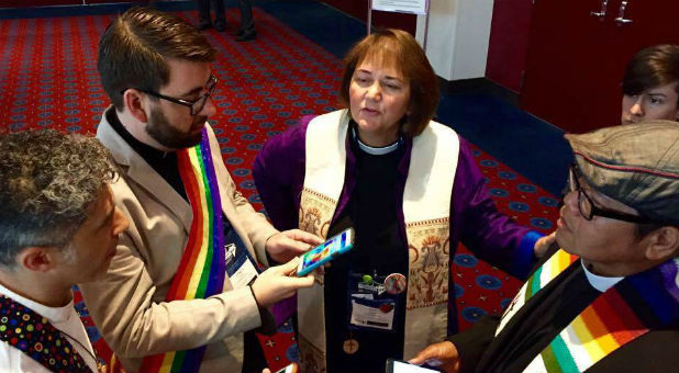 Karen Oliveto, center, meets with other gay clergy members.