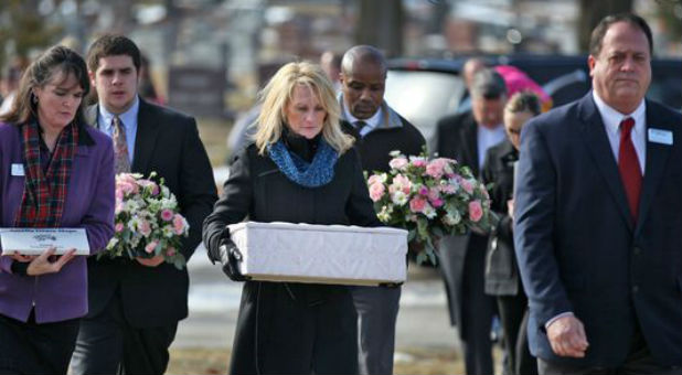 Linda Znachko prepares for a graveside service for one of the babies.
