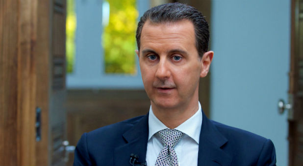 Syria's President Bashar al-Assad speaks during an interview with AFP news agency in Damascus