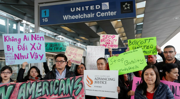 Community members protest the treatment of Dr. David Dao, who was forcibly removed from a United Airlines flight on Sunday by the Chicago Aviation Police