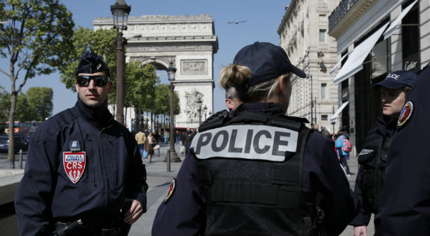French CRS police patrol the Champs Elysees Avenue the day after a policeman was killed and two others were wounded in a shooting incident in Paris, France