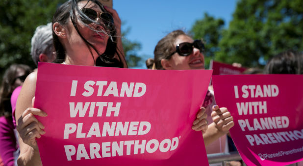 Demonstrators hold placards during a Planned Parenthood rally outside the State Capitol in Austin, Texas.