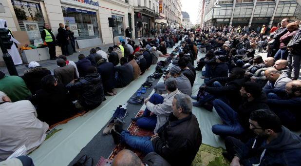 Muslims pray during Friday prayers in the street in front of the city hall of Clichy, near Paris, France, April 21, 2017, after an unauthorised place of worship was closed by local authorities.