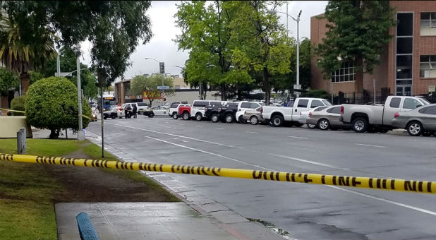 A road is blocked by police tape after a shooting incident in downtown Fresno, California.