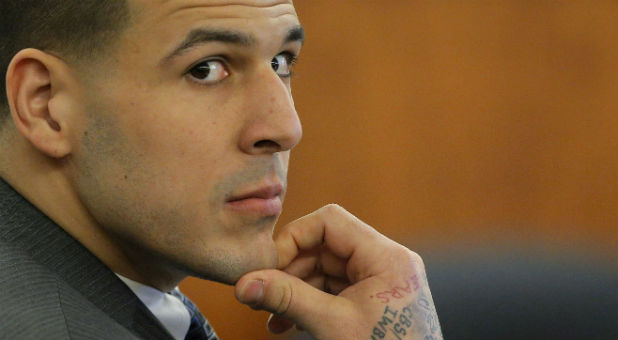 Former New England Patriots football player Aaron Hernandez listens as prosecution witness Alexander Bradley testifies at Bristol County Superior Court in Fall River, Massachusetts, April 1, 2015.