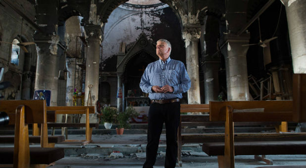 Evangelist Franklin Graham stands in a church destroyed by the Islamic State.