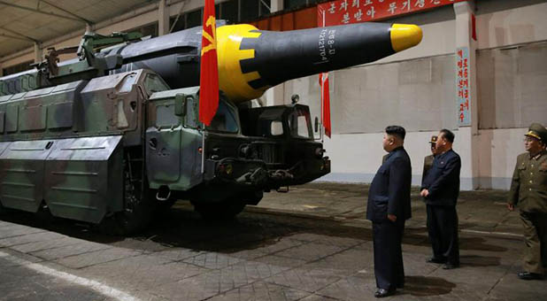 North Korean dictator Kim Jong-un inspecting a Hwasong-12 missile