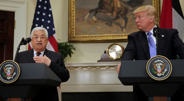 Palestinian President Mahmoud Abbas delivers a statement accompanied by U.S. President Donald Trump during a visit to the White House