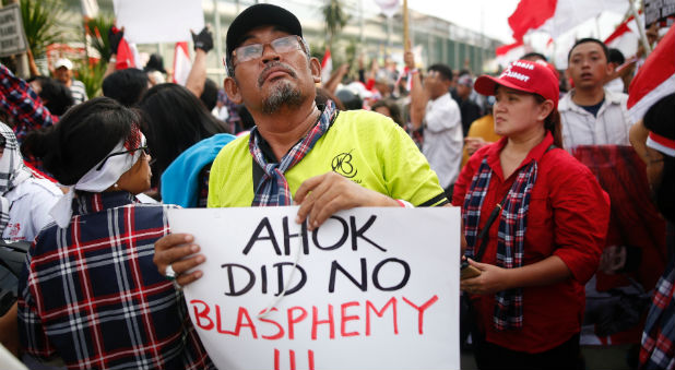 Supporters of Jakarta Governor Basuki Tjahaja Purnama, also known as Ahok, stage a protest outside Cipinang Prison, where he was taken following his conviction of blasphemy, in Jakarta, Indonesia