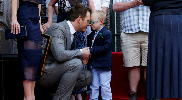 Actor Chris Pratt shares a moment with his four-year old son Jack Pratt while his wife Anna Faris (L) holds a plaque next to them in Hollywood.