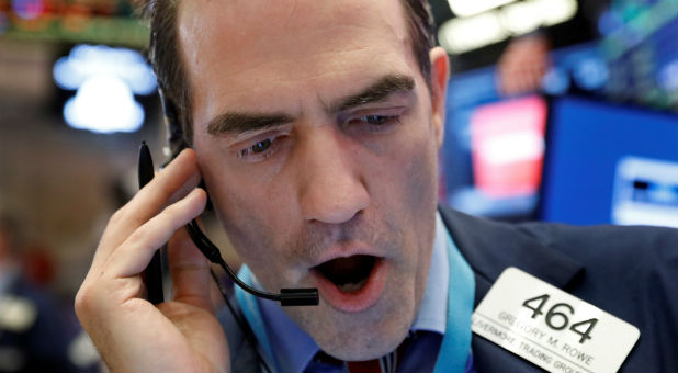 Trader Greg Rowe works on the floor of the New York Stock Exchange (NYSE) in New York
