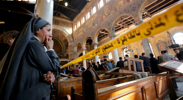 A nun cries as she stands at the scene inside Cairo's Coptic cathedral, following a bombing
