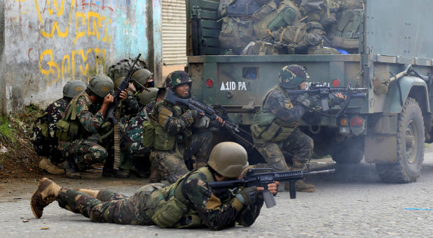 Government troops are seen during an assault on insurgents from the so-called Maute group, who have taken over large parts of Marawi City, in Marawi City, southern Philippines