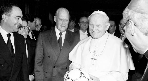 Pope John Paul II holds a ball to be used in the World Cup Soccer opening game as FIFA President Joao Havelange looks on in Rome December 9, 1989.
