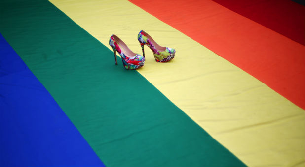High heel shoes are seen on a rainbow flag during a protest by the LGBT community.