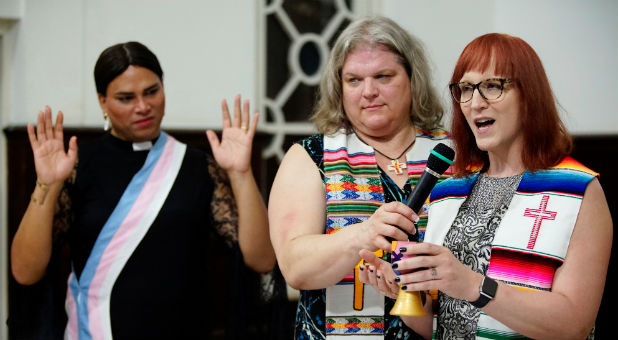 Trans pastors Cindy Bourgeois from Canada (C) and Alexya Salvador from Brazil listen to trans Baptist reverend Allyson Robinson from the U.S. during a mass in Matanzas, Cuba