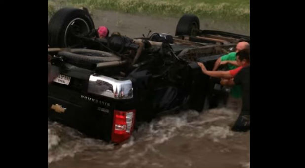 The parents of two children rescued by good Samaritans who were trapped in a flooded and overturned truck are sharing their gratitude.