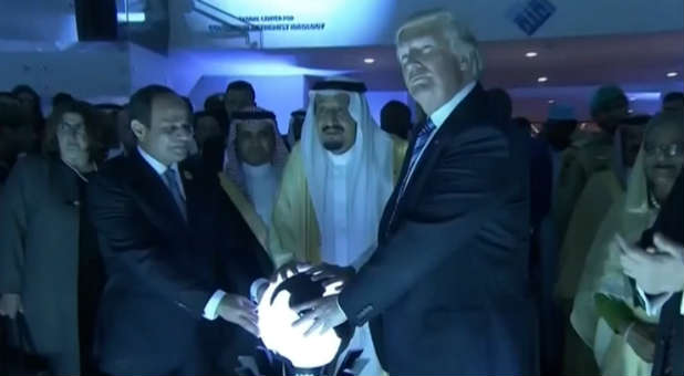 Donald Trump places his hands on a glowing orb as he tours with other leaders the Global Center for Combating Extremist Ideology in Riyadh, Saudi Arabia.
