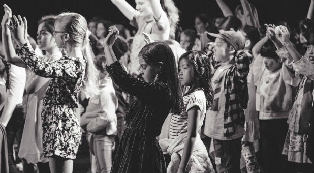Children worship at a Hillsong event.