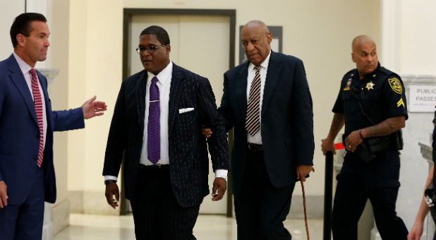 Lawyer Fortunato N. Perri Jr. (L) waits for Andrew Wyatt (2nd L) to guide Bill Cosby back to the courtroom after lunch on the first day of Cosby's trial for sexual assault at the Montgomery County Courthouse in Norristown, Pennsylvania.