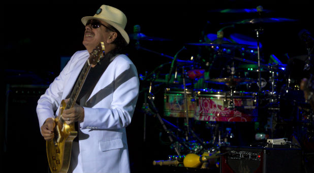 Rock 'n' roll legend Carlos Santana performs at a music festival.