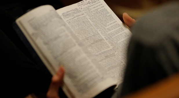 A woman reads her Bible before the Exalt Showcase of Gospel and Christian music at Central Presbyterian Church at the South by Southwest (SXSW) Music Film Interactive Festival.
