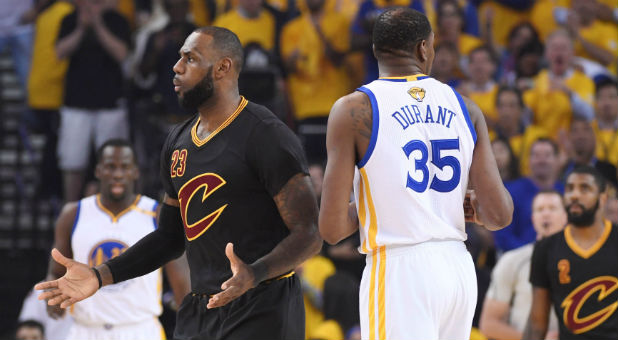 Cleveland Cavaliers forward LeBron James (23) reacts after being called for a foul against Golden State Warriors forward Kevin Durant (35) during the first quarter in Game 5 of the 2017 NBA Finals at Oracle Arena.