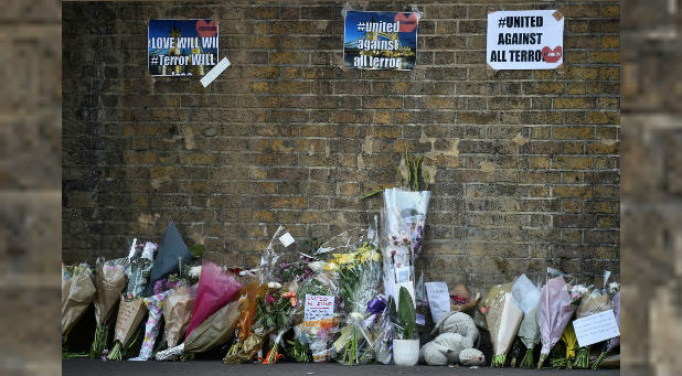 Messages and tributes are left near the site where a van was driven at Muslims in Finsbury Park, North London.