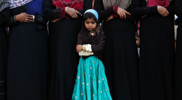 A Muslim girl offers Eid al-Fitr prayers inside a school to mark the end of the holy fasting month of Ramadan.