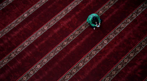 A Muslim man sits inside a mosque during the holy month of Ramadan.