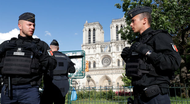 French gendarmes stand at the scene of a shooting incident near the Notre Dame Cathedral in Paris, France.