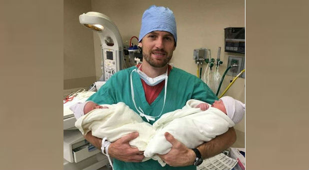 Gentry Eddings holds his newborn sons, Isaiah and Amos.